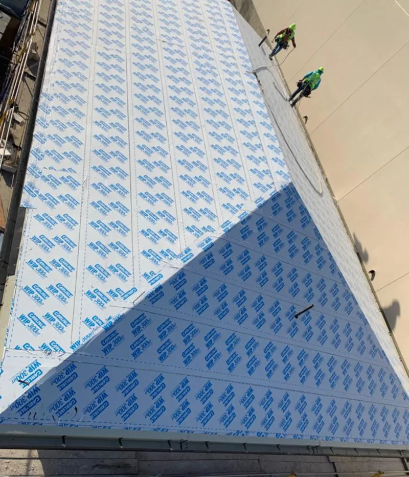 Professional roofers installing underlayment on a metal roof in South Venice